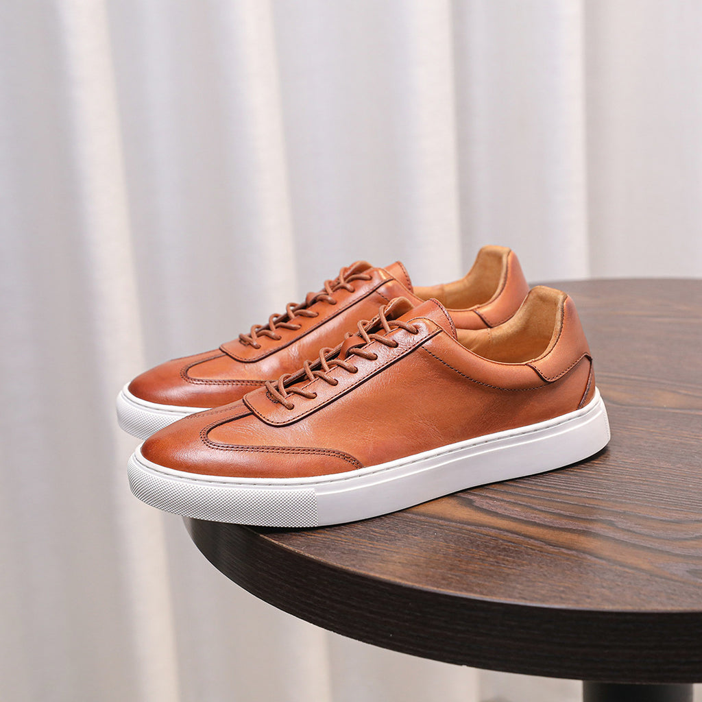 Brown leather lace-up sneakers with white midsole and smooth stitched toe panel