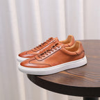 Brown leather lace-up sneakers with white midsole and smooth stitched toe panel