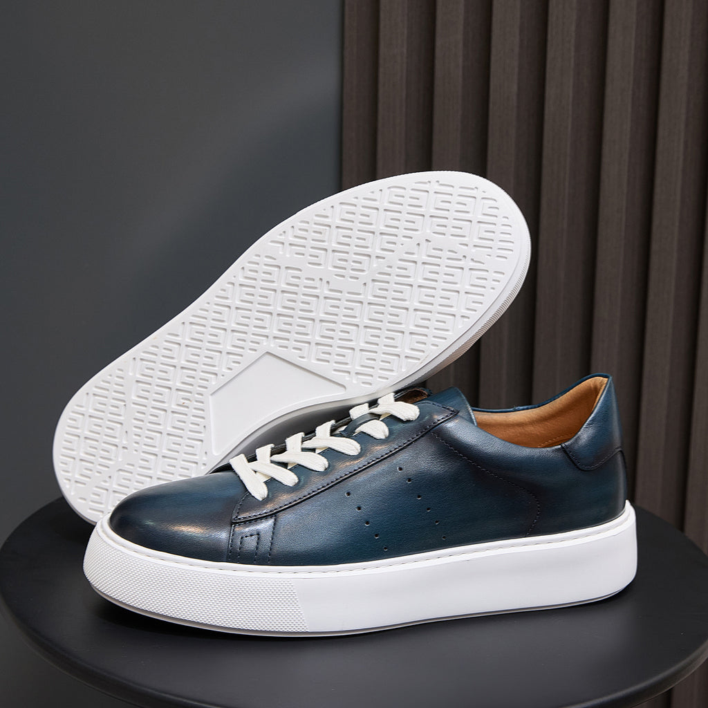 Blue leather low-top sneakers with textured white outsole and white midsole
