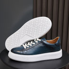 Blue leather low-top sneakers with textured white outsole and white midsole