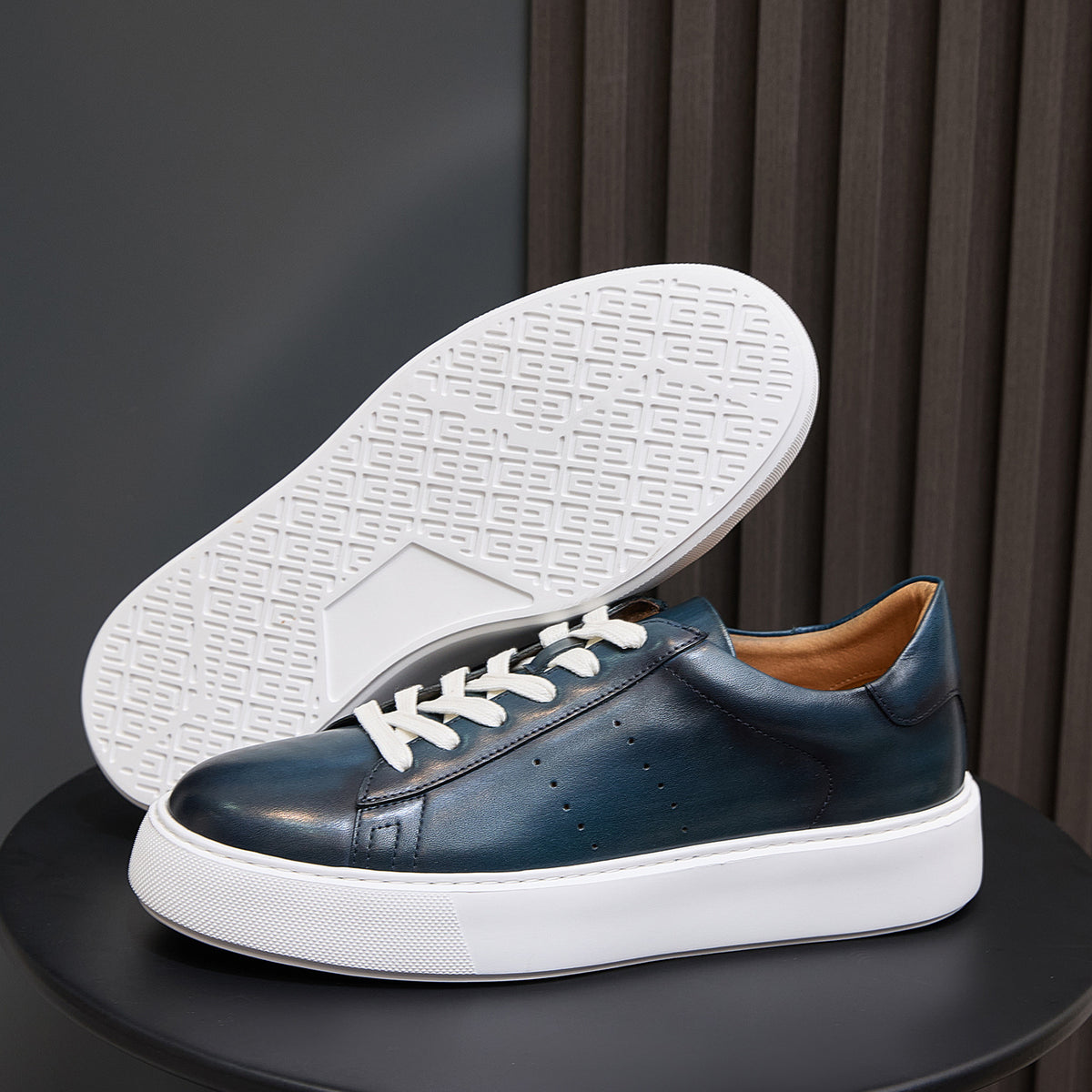Blue leather low-top sneakers with textured white outsole and white midsole