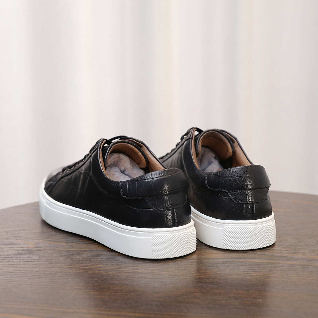 Men's black genuine leather sneakers, rear view with white rubber cup sole.
