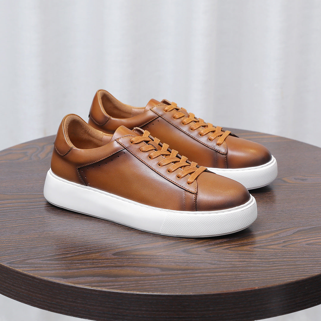 Men's brown leather low-top sneakers with lace-up closure and white platform sole