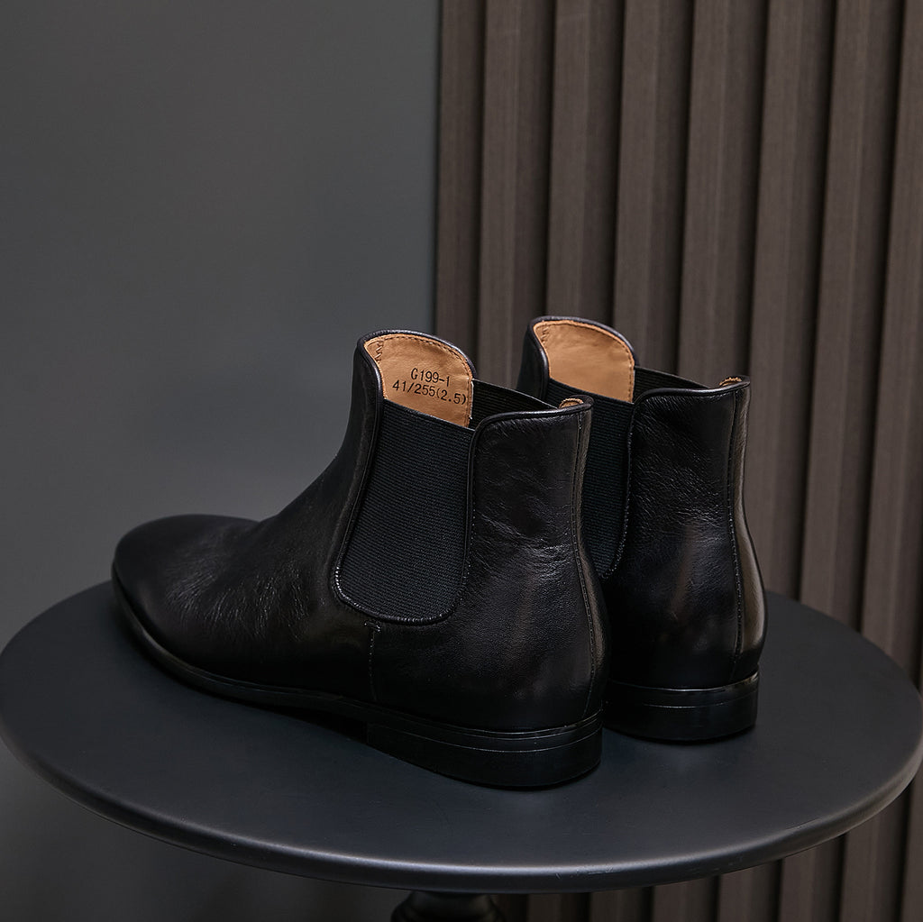 Pair of black Chelsea dress boots, pointed toe and elastic side panels