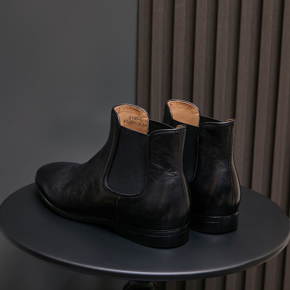 Pair of black Chelsea dress boots, pointed toe and elastic side panels