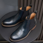 Men's suede chelsea dress boots, blue angled view with elastic ankle gore