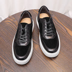 Black leather lace-up sneakers with padded tongue and white rubber sole