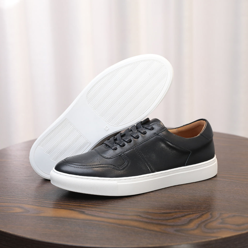 Black leather sneakers with white outsole, lace-up front and side panels