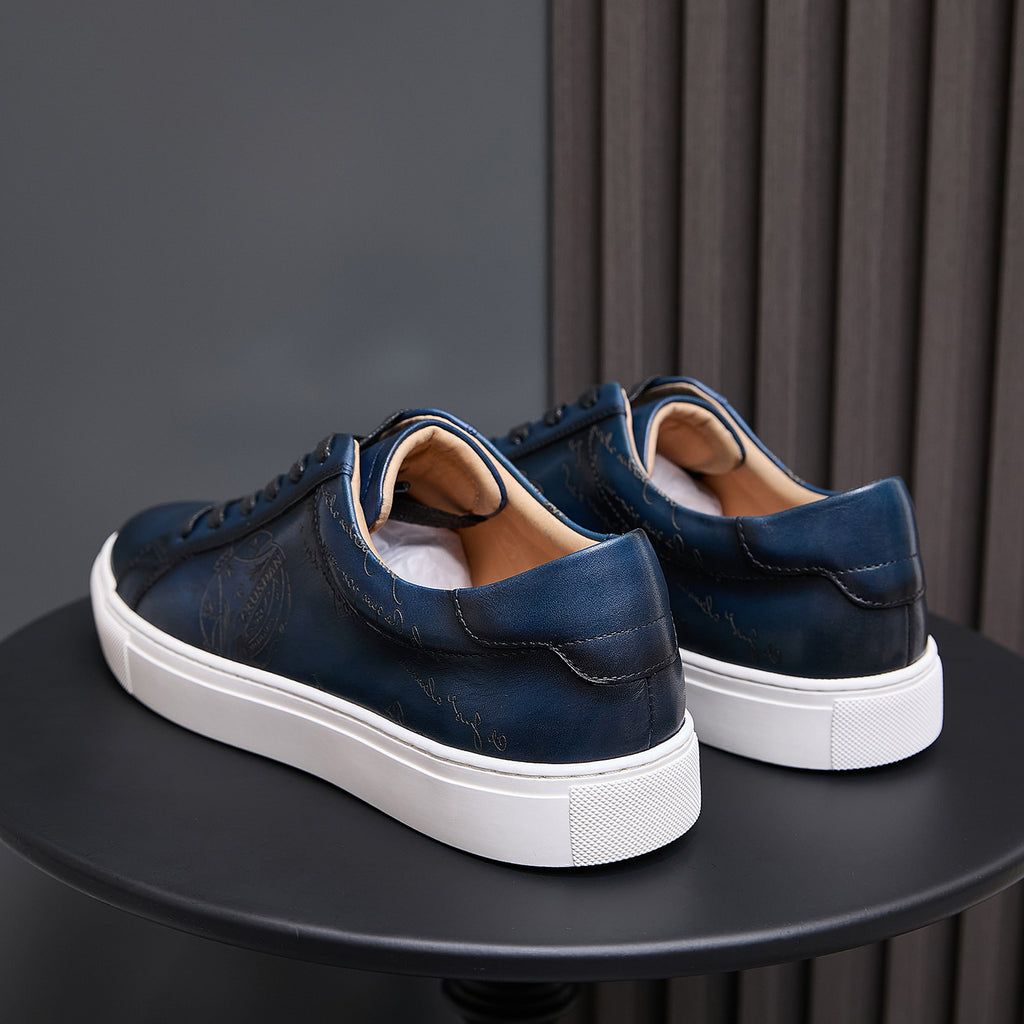 Men's blue leather sneakers rear view with padded collar and white rubber sole