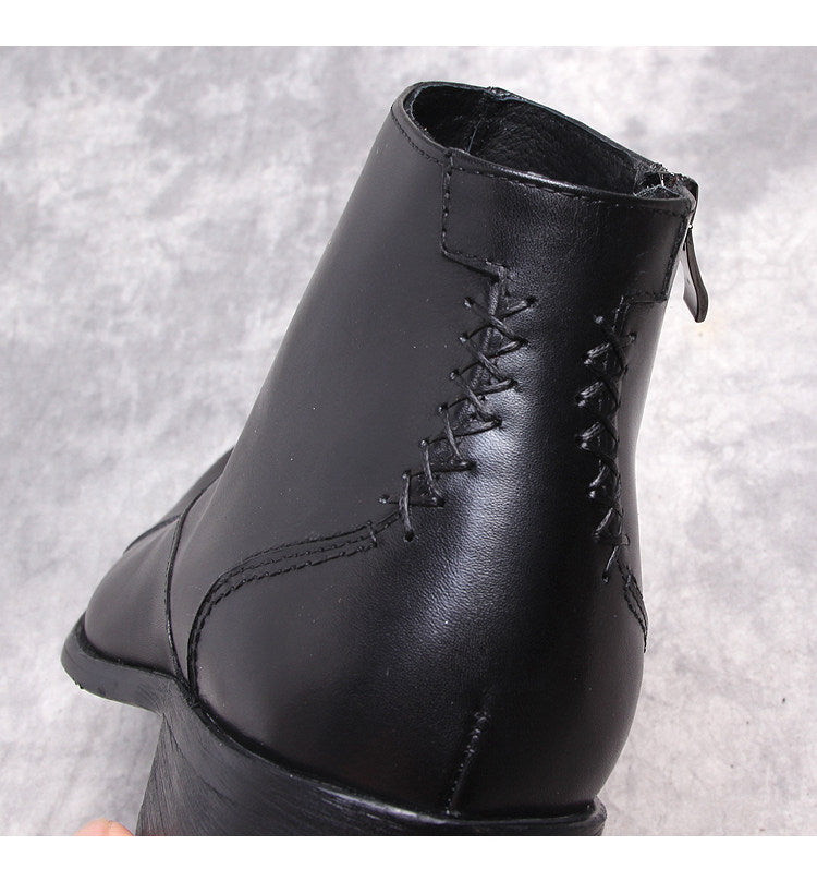 Black leather side-zip dress boot with lace-like stitched detail