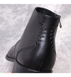 Black leather side-zip dress boot with lace-like stitched detail