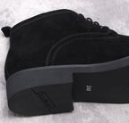 Men's dark suede boot outsole with tread and heel, side view