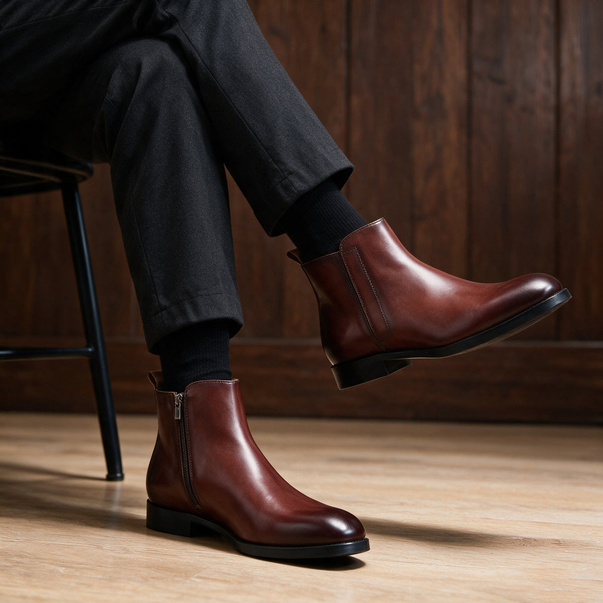 Pointed-toe leather side-zip dress boots in brown, worn with dark trousers