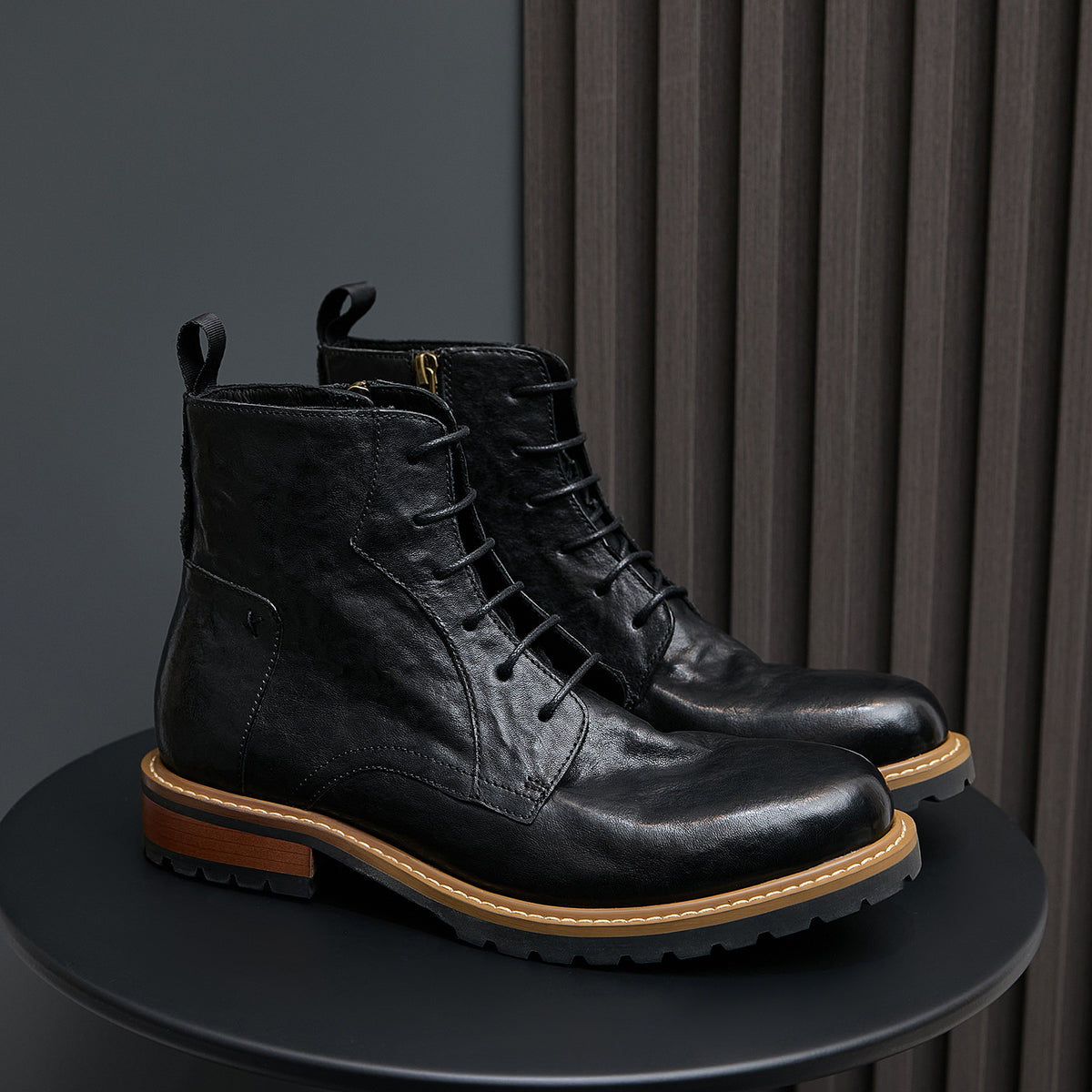Men's black leather lace-up ankle boots with pointed toe and side zipper.
