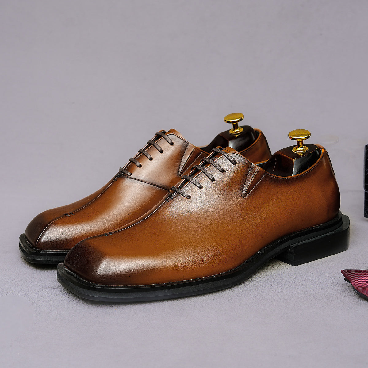 Men's chunky lug-sole wingtip brogue oxfords, tan leather look, lace-up front view.