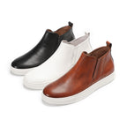 Men’s leather side-zip ankle boots in black, white, and brown with white rubber soles