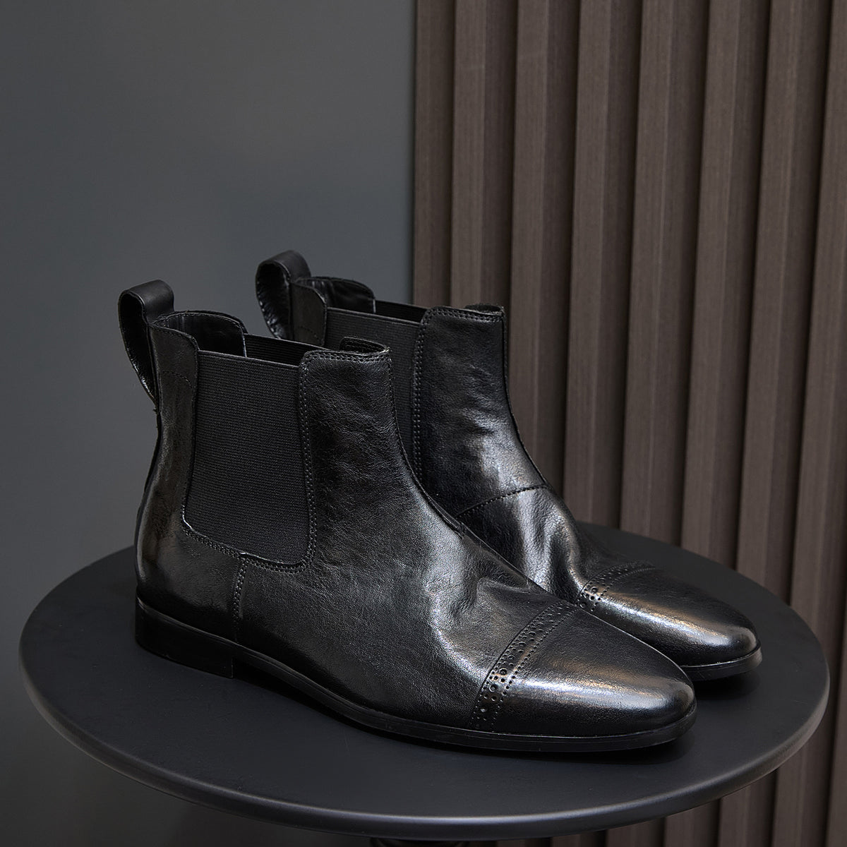 Pair of black pointed-toe Chelsea dress boots with elastic side panels