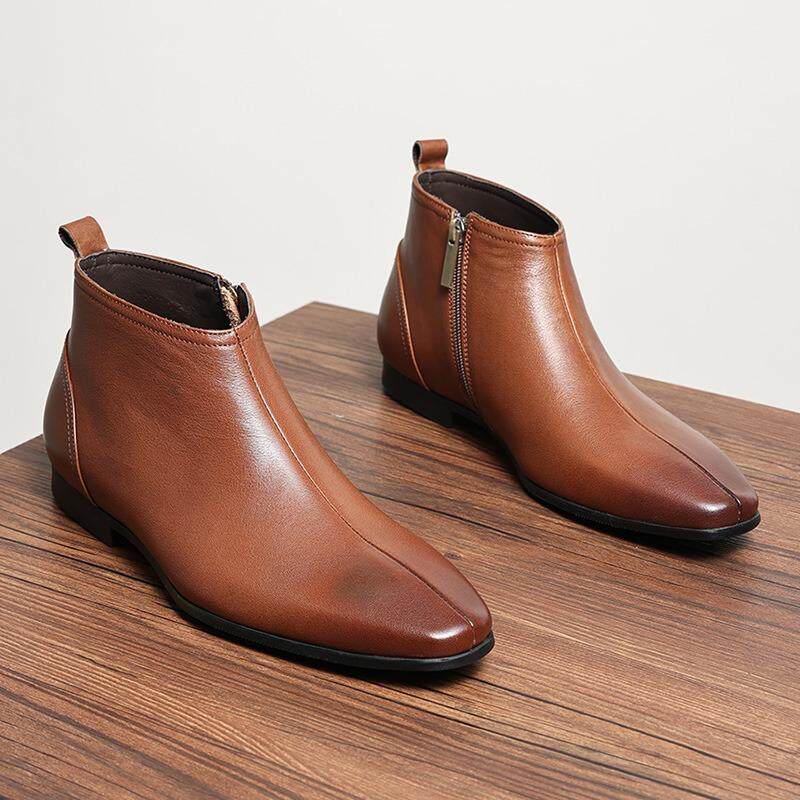 Pair of brown leather ankle boots with side zippers and thick rubber soles.