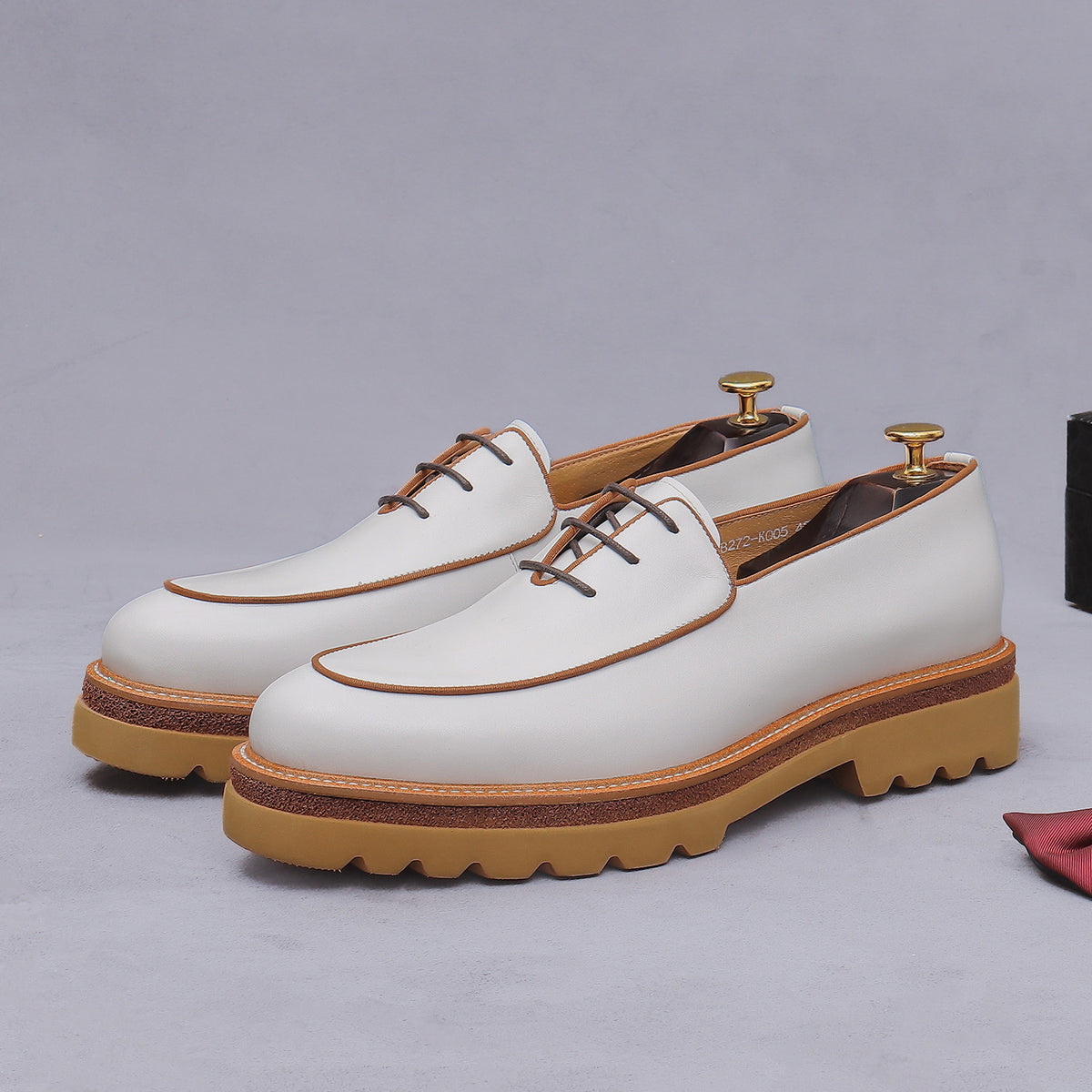 Men's chunky lug-sole wingtip oxfords, white leather with brown edge trim