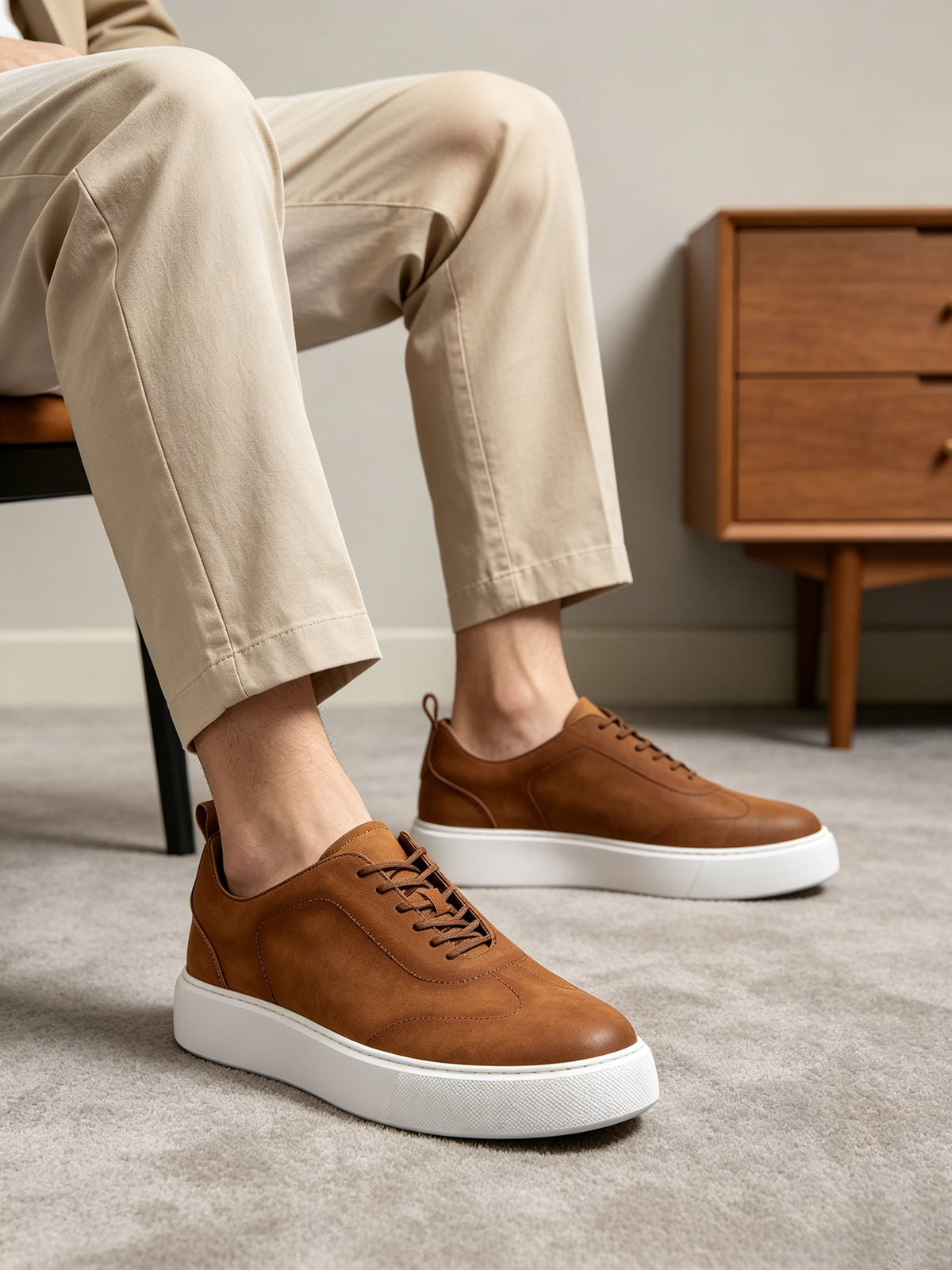 Brown leather sneakers with lace-up front and white rubber sole