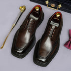 Men's chunky lug-sole wingtip brogue oxford shoes, dark brown, lace-up angled pair view.
