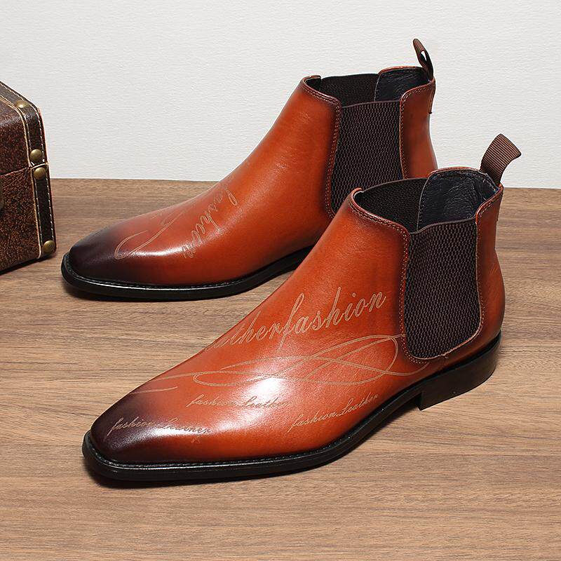 Pair of brown Chelsea dress boots with elastic gore panels and low-profile heel