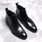 Pair of black leather side-zip ankle boots with thick sole and low block heel