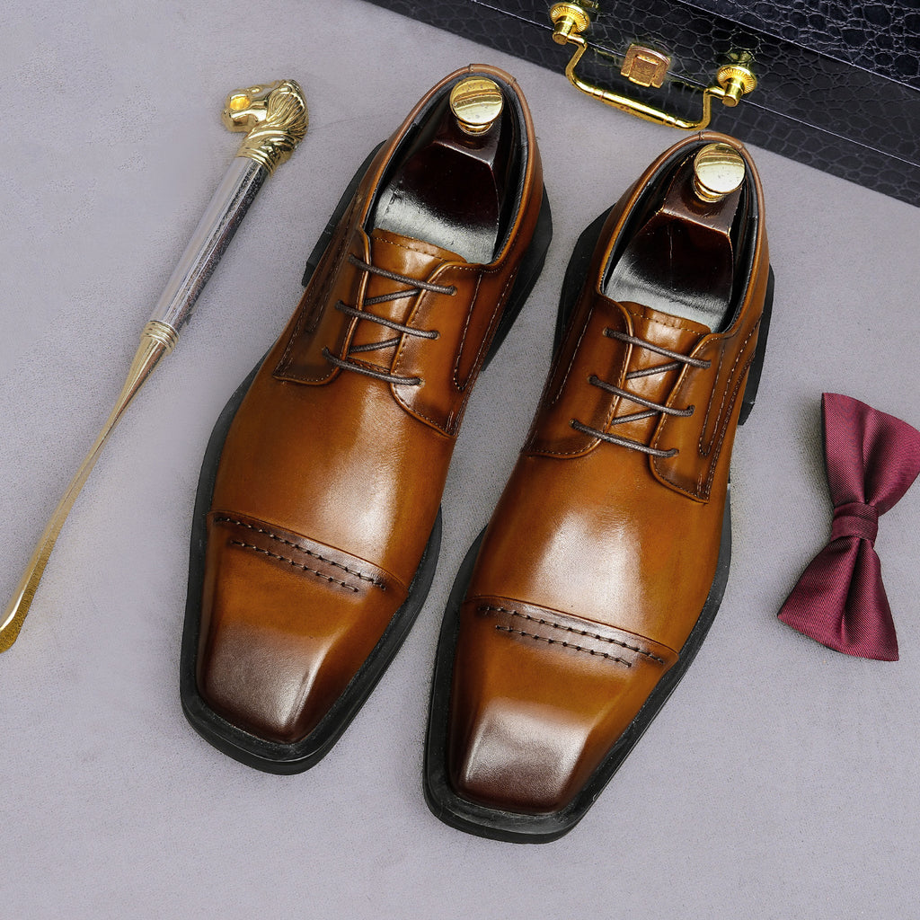 Men's brown leather lace-up derby dress shoes, pointed toe with polished finish and stitching.