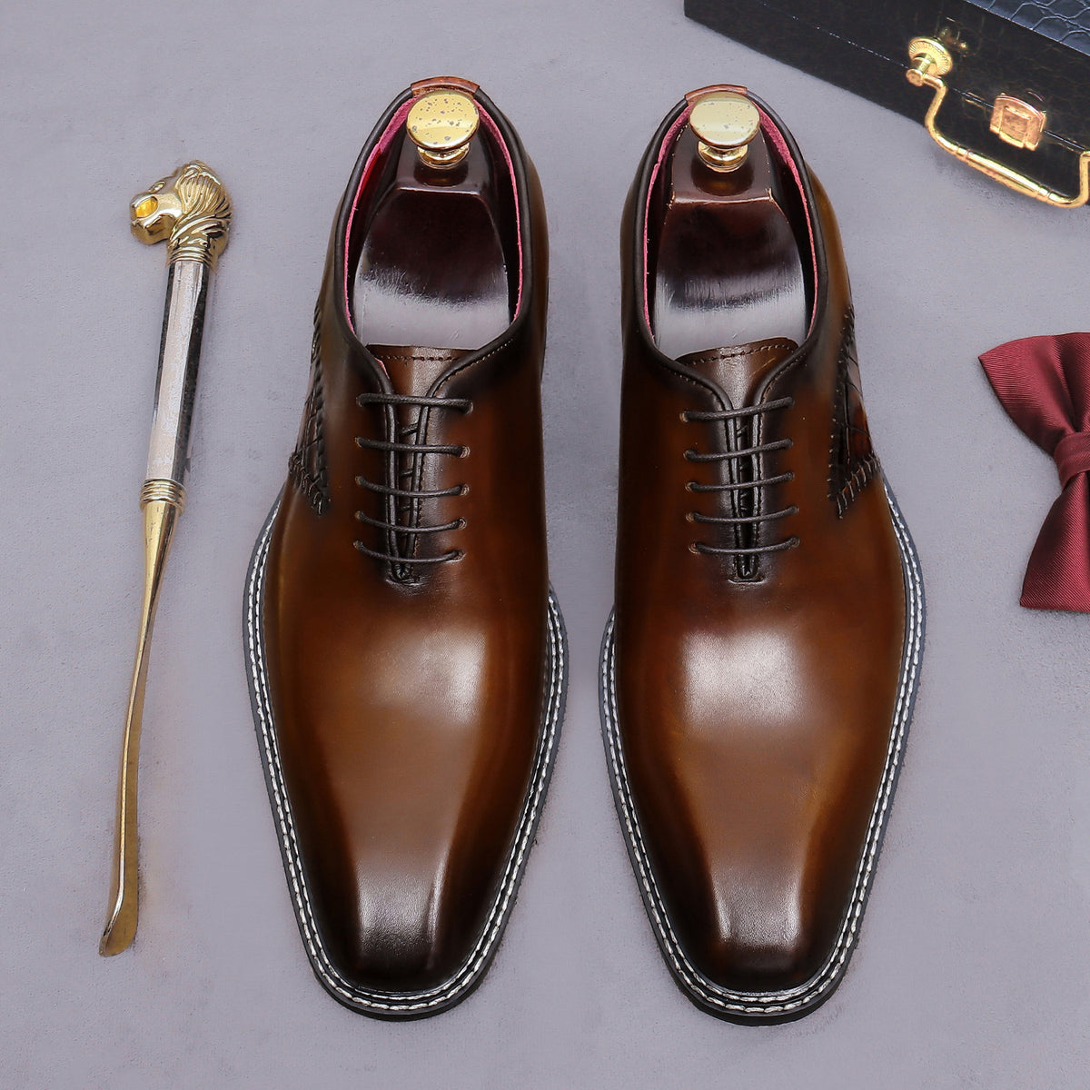 Brown wingtip brogue oxford shoes with chunky lug sole and lace-up pair