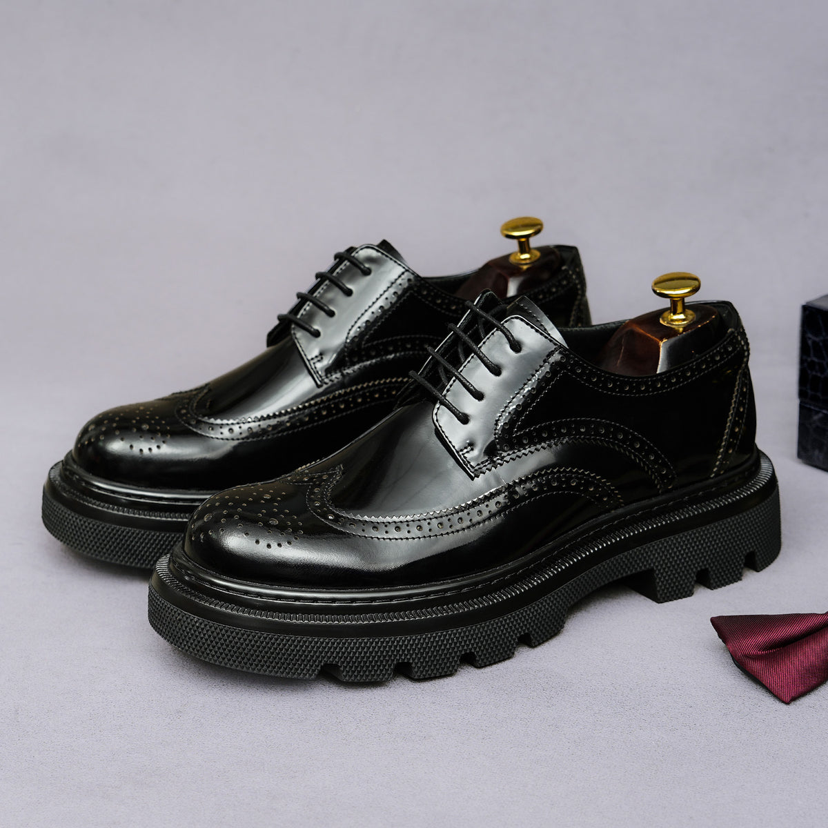 Men's leather derby shoes, glossy black and silver panels with pointed toe and lace-up.