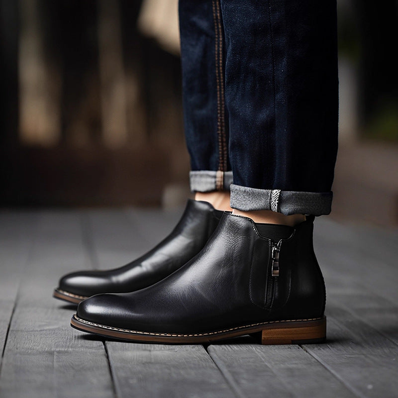 Black pointed-toe side-zip dress boots with brown welt under jeans cuffs