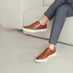 Men's brown leather low-top sneakers with white rubber sole and lace-up front