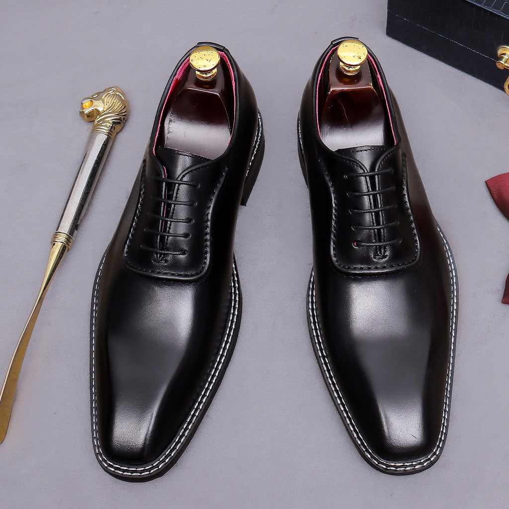 Men's chunky lug sole wingtip brogue oxford shoes in black, front lace-up pair view.