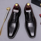 Men's chunky lug sole wingtip brogue oxford shoes in black, front lace-up pair view.