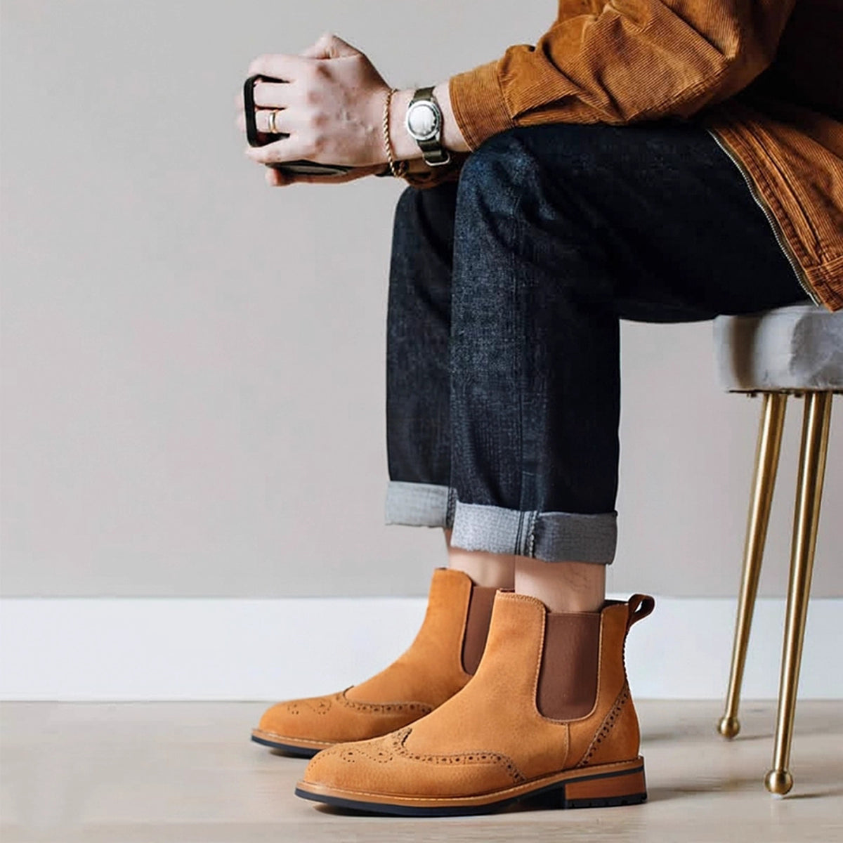 Tan suede pointed-toe Chelsea boots on model, elastic side panels and tan sole