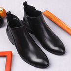 Pair of black leather ankle dress boots with side zips and pull tabs