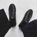 Men's black leather sneakers with lace-up closure and low-profile sole