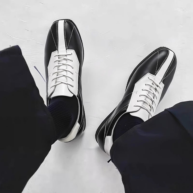 Black leather low-top sneakers with white side panels and lace-up front.