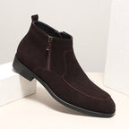 Dark brown suede side-zip ankle boots with thick sole and decorative stitching along vamp