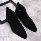 Pair of black suede side-zip dress boots with thick soles, angled top view.