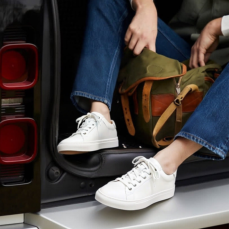 Men's white leather low-top sneakers with lace-up front and rubber cupsole