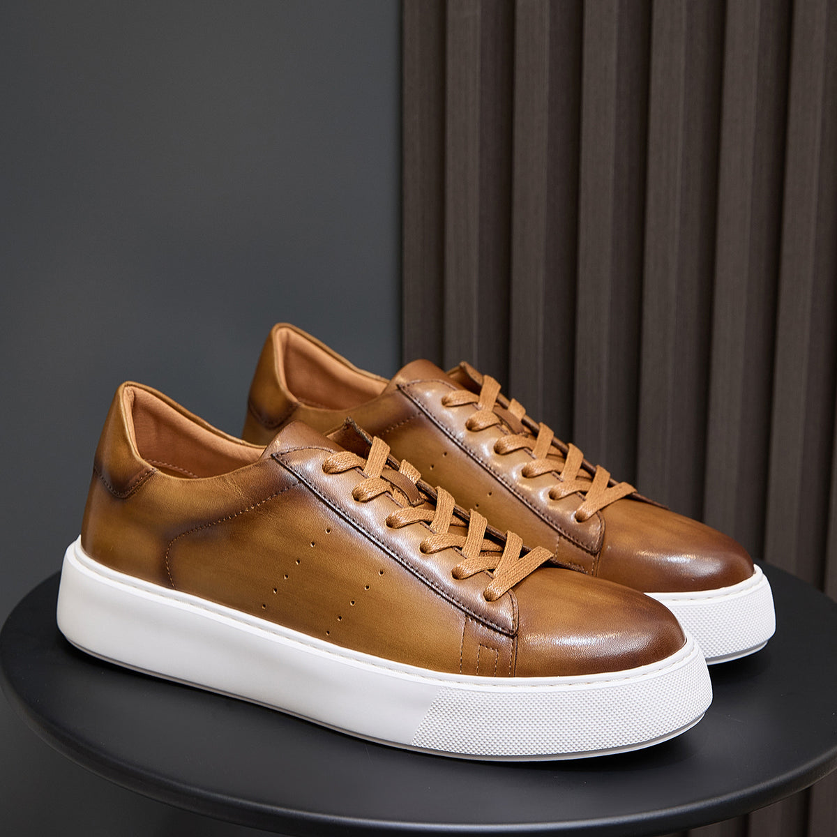 Men's brown leather lace-up sneakers with white rubber sole and low-profile design