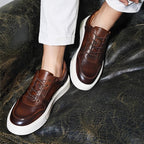 Men's dark brown leather sneakers with lace-up design and white rubber sole