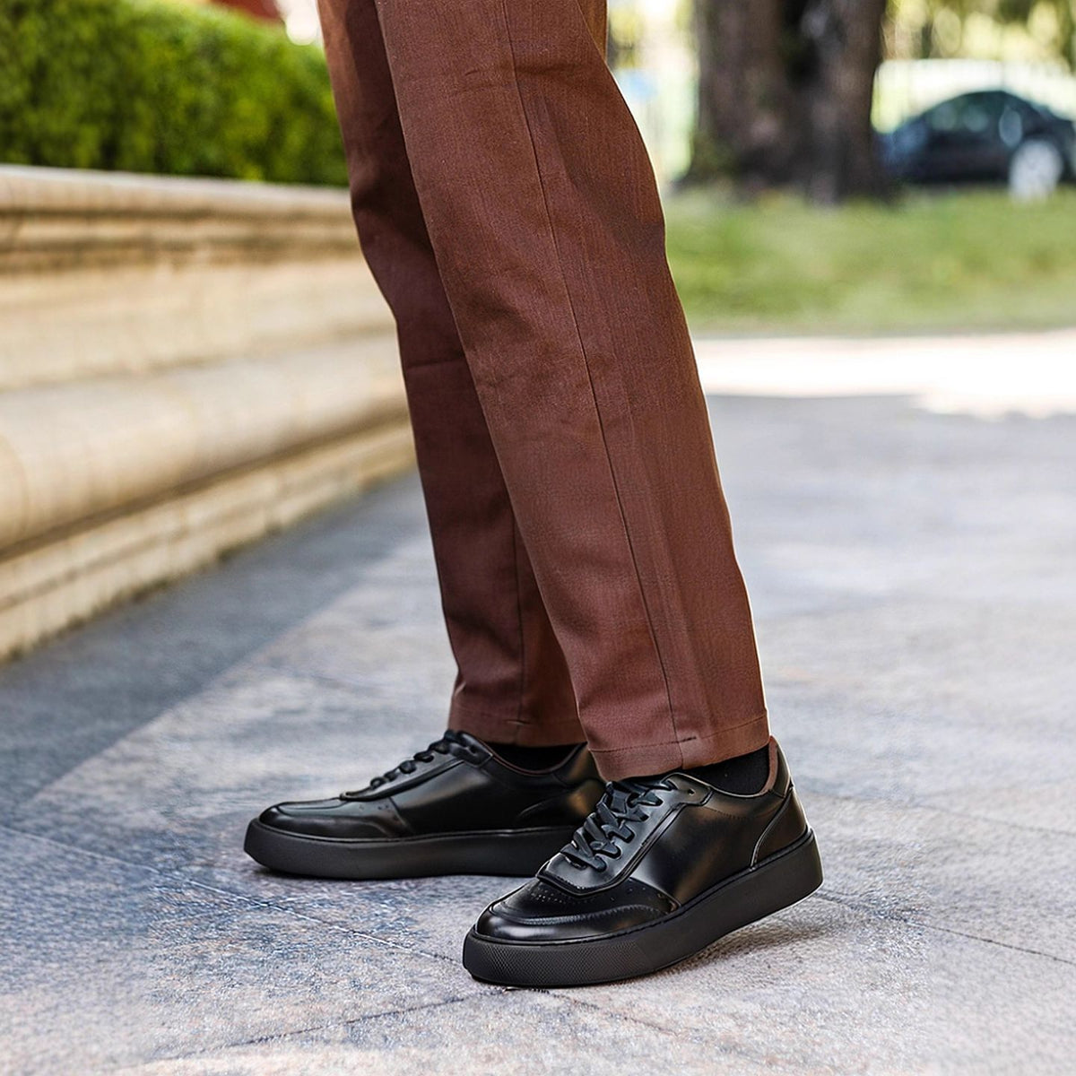 Men's leather sneakers, black, lace-up low profile with thick rubber sole.