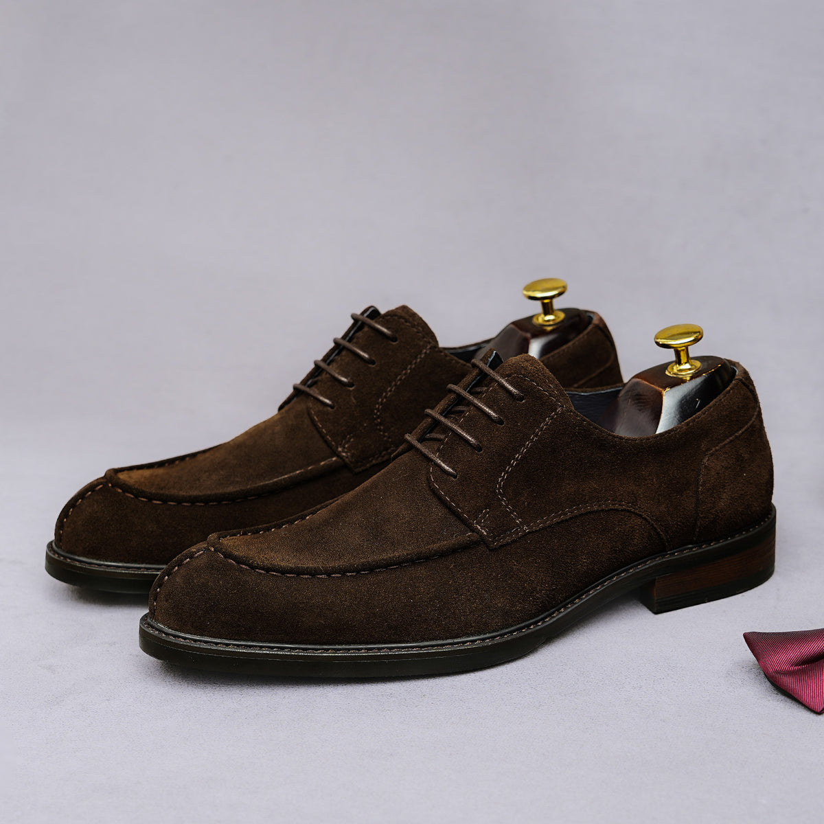 Men's brown suede wingtip Oxford shoes with chunky lug sole and lace-up