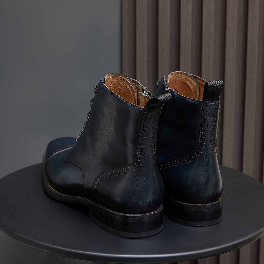 Leather ankle boots heel view with lace-up front and side panel, dark blue finish.