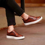 Brown leather sneakers on model, lace-up casual shoes with white sole
