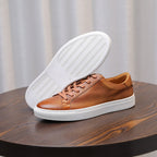 Brown leather sneakers with tan laces and white outsole tread for grip