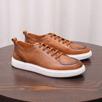 Brown leather low-top sneakers with lace-up closure and white rubber platform sole