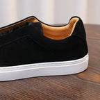 Men's black suede leather sneaker with padded collar and white sidewall sole.